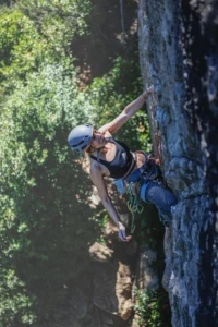 Female Rock Climber Scaling a Cliff Outdoors