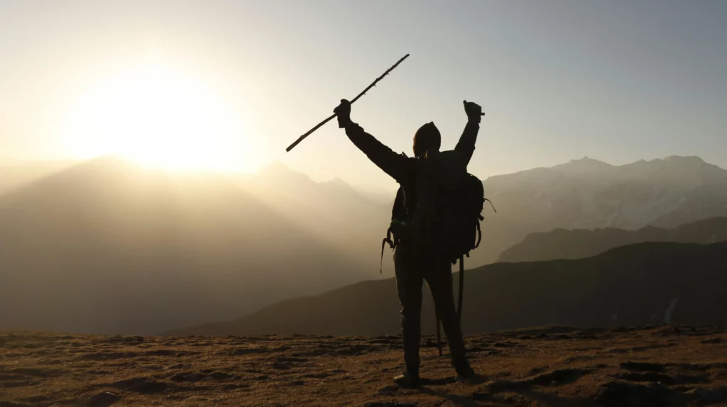 Person with Arms Raised Holding a Stick