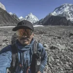 man's selfie taken in concordia with sunglasses, background mountains