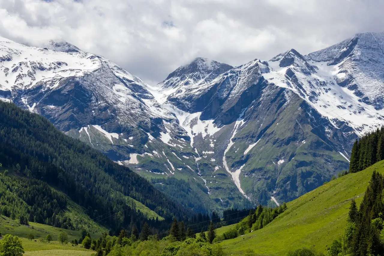 Snow Capped Mountains Under Cloudy Sky