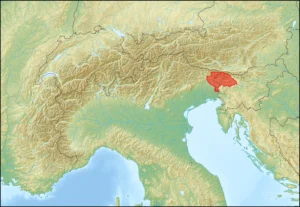 : A topographic map of the Alps region with the country of Slovenia highlighted in red, showing its position between Austria, Italy, Hungary, and Croatia.