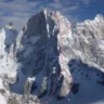 Snowy, sharp mountain massif with a red overlay showing a technical climbing route from summit A (left) to B (right) via col R, including variant sections labeled 1 and 2 on the steep face and ridge.