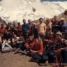 group of mountaineers standing together, front of snowy mountain