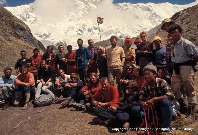 group of mountaineers standing together, front of snowy mountain